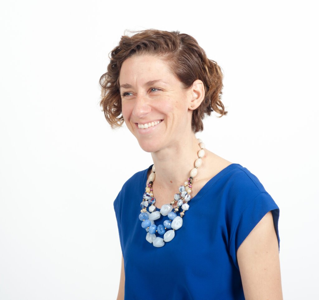 Sarah Fraser smiling wearing an electric blue t-shirt